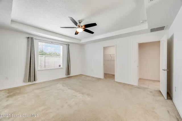 a bedroom with a bed couch and window