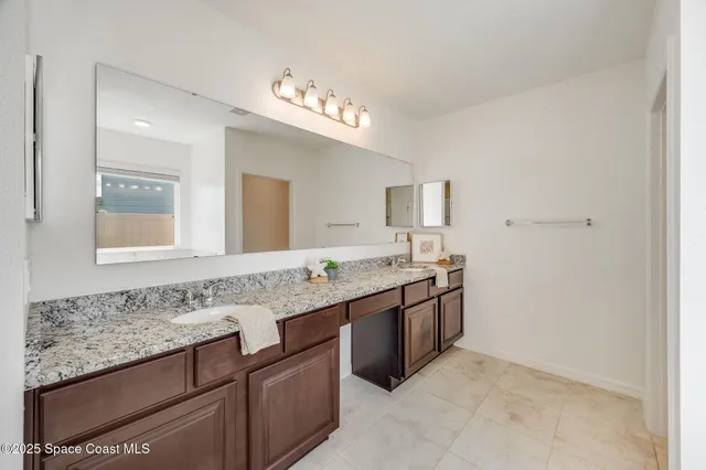 a white toilet sitting next to a white wall