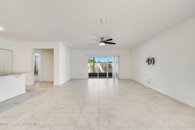 a view of livingroom with furniture and chandelier fan
