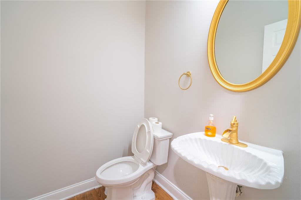 3819 Meandering Way Southwest Lilburn, GA 30047 - Photo 13 of 27 a bathroom with a sink and a mirror