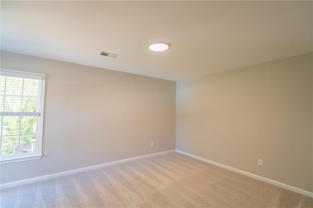 3819 Meandering Way Southwest Lilburn, GA 30047 - Photo 19 of 27 an empty room with a window