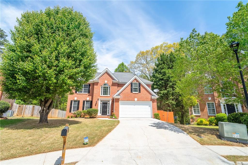 3819 Meandering Way Southwest Lilburn, GA 30047 - Photo 2 of 27 a front view of a house with a yard
