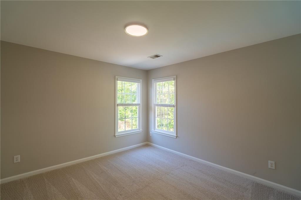 3819 Meandering Way Southwest Lilburn, GA 30047 - Photo 22 of 27 an empty room with windows