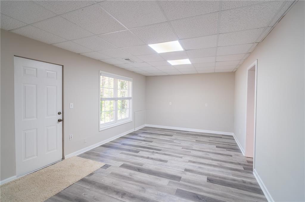 3819 Meandering Way Southwest Lilburn, GA 30047 - Photo 25 of 27 a view of an empty room with wooden floor and window