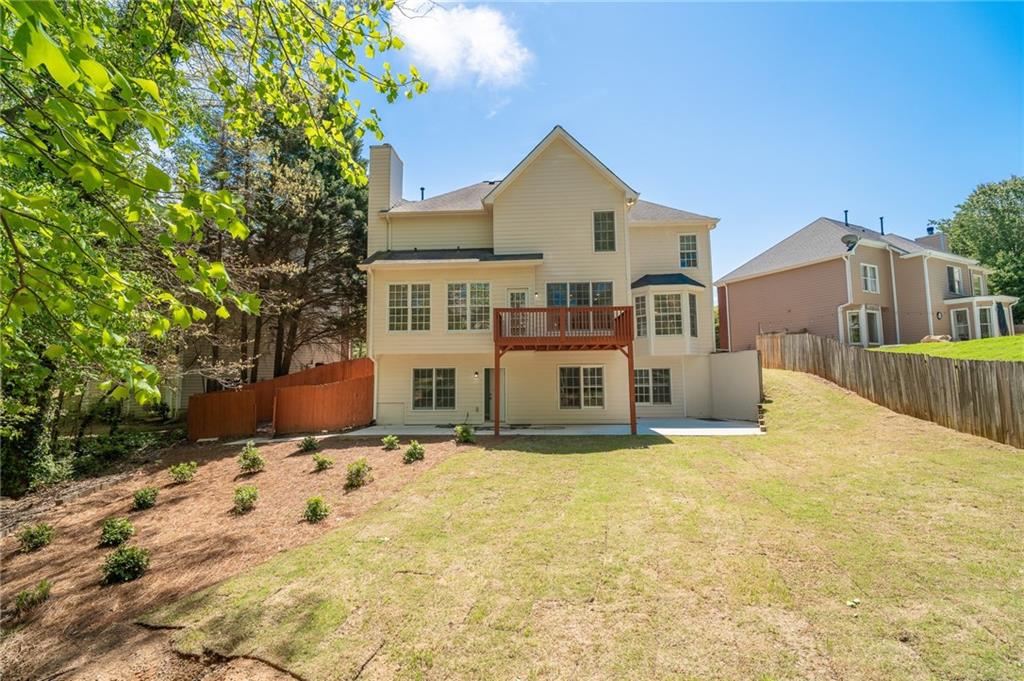 3819 Meandering Way Southwest Lilburn, GA 30047 - Photo 27 of 27 a view of a house with a yard
