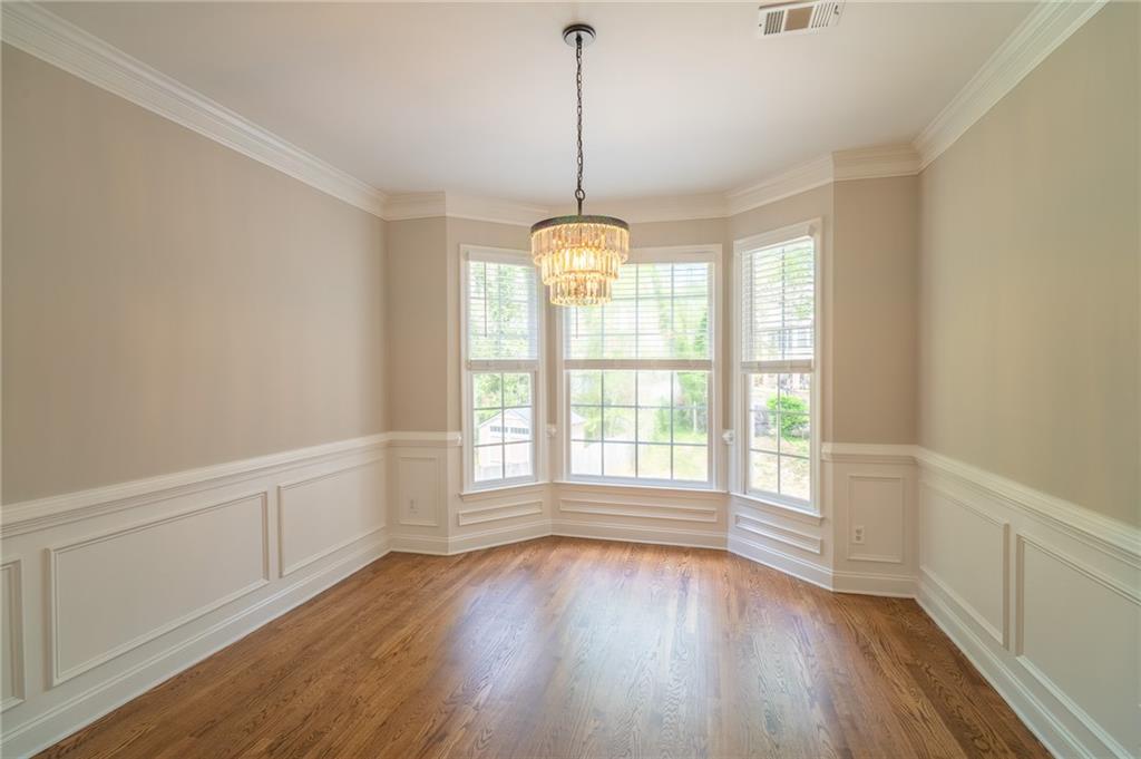 3819 Meandering Way Southwest Lilburn, GA 30047 - Photo 5 of 27 a view of an empty room with wooden floor and a window