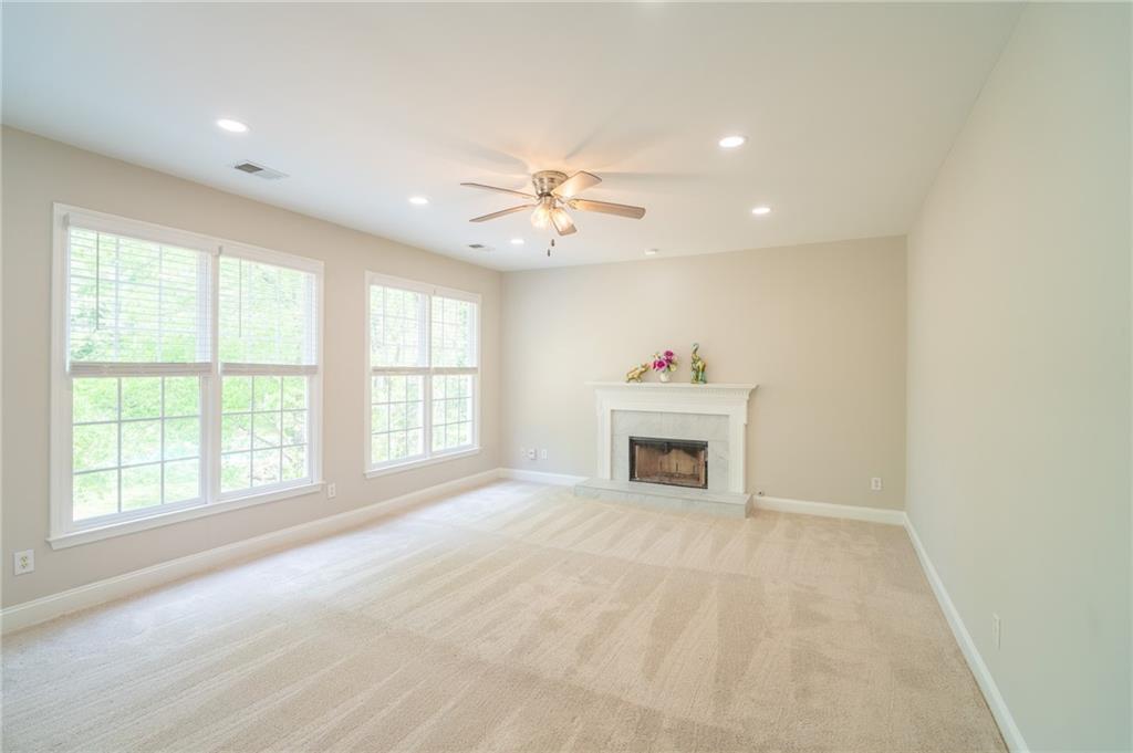 3819 Meandering Way Southwest Lilburn, GA 30047 - Photo 10 of 27 an empty room with windows and fireplace