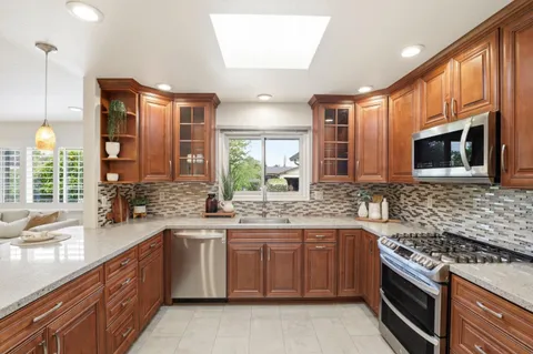 a kitchen with a sink stove and microwave