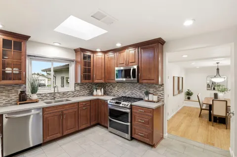 a large kitchen with stainless steel appliances lots of counter space and a sink