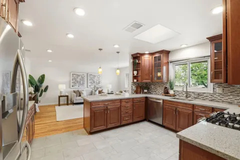 a large kitchen with lots of counter space and sink
