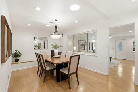 a view of a dining room with furniture and wooden floor