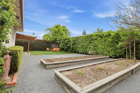 an aerial view of a house with a yard and plants