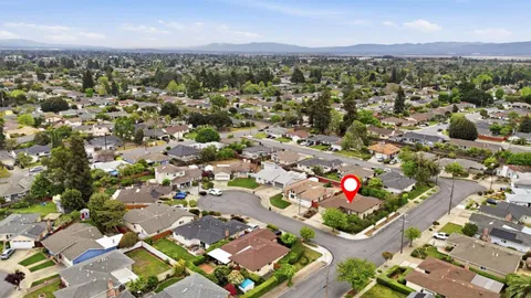 a view of a house with a swimming pool and a yard