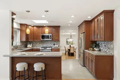 a kitchen with stainless steel appliances granite countertop counter space a sink and cabinets