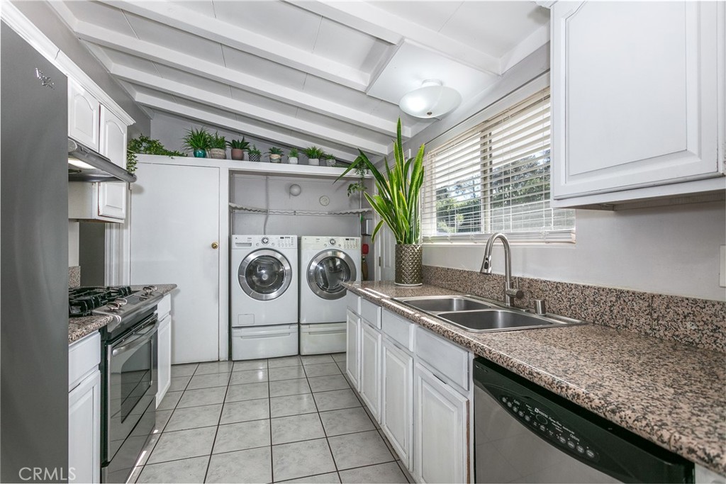 20626 Haynes Street Winnetka, CA 91306 - Photo 23 of 28 a kitchen with a sink a stove top oven and cabinets