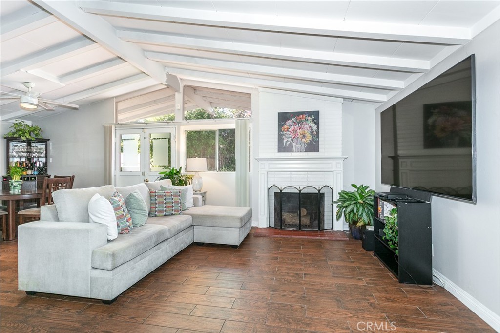 20626 Haynes Street Winnetka, CA 91306 - Photo 6 of 28 a living room with furniture a flat screen tv and a fireplace