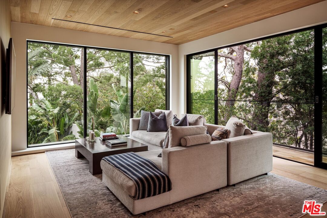 1663 Summitridge Drive Beverly Hills, CA 90210 - Photo 16 of 22 a living room with furniture and a large window