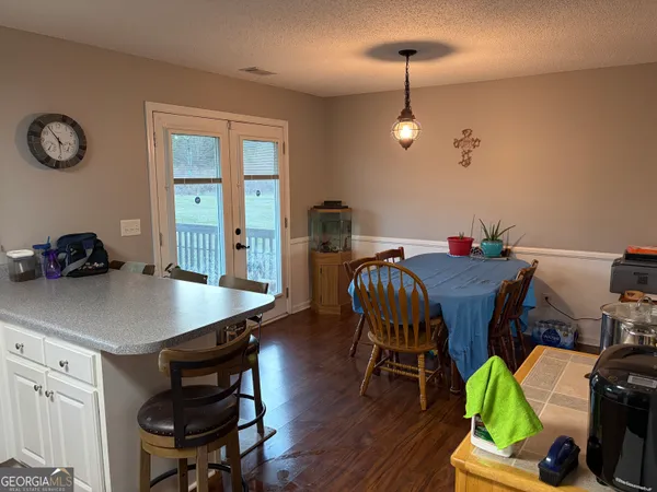 a view of a dining room with furniture and wooden floor