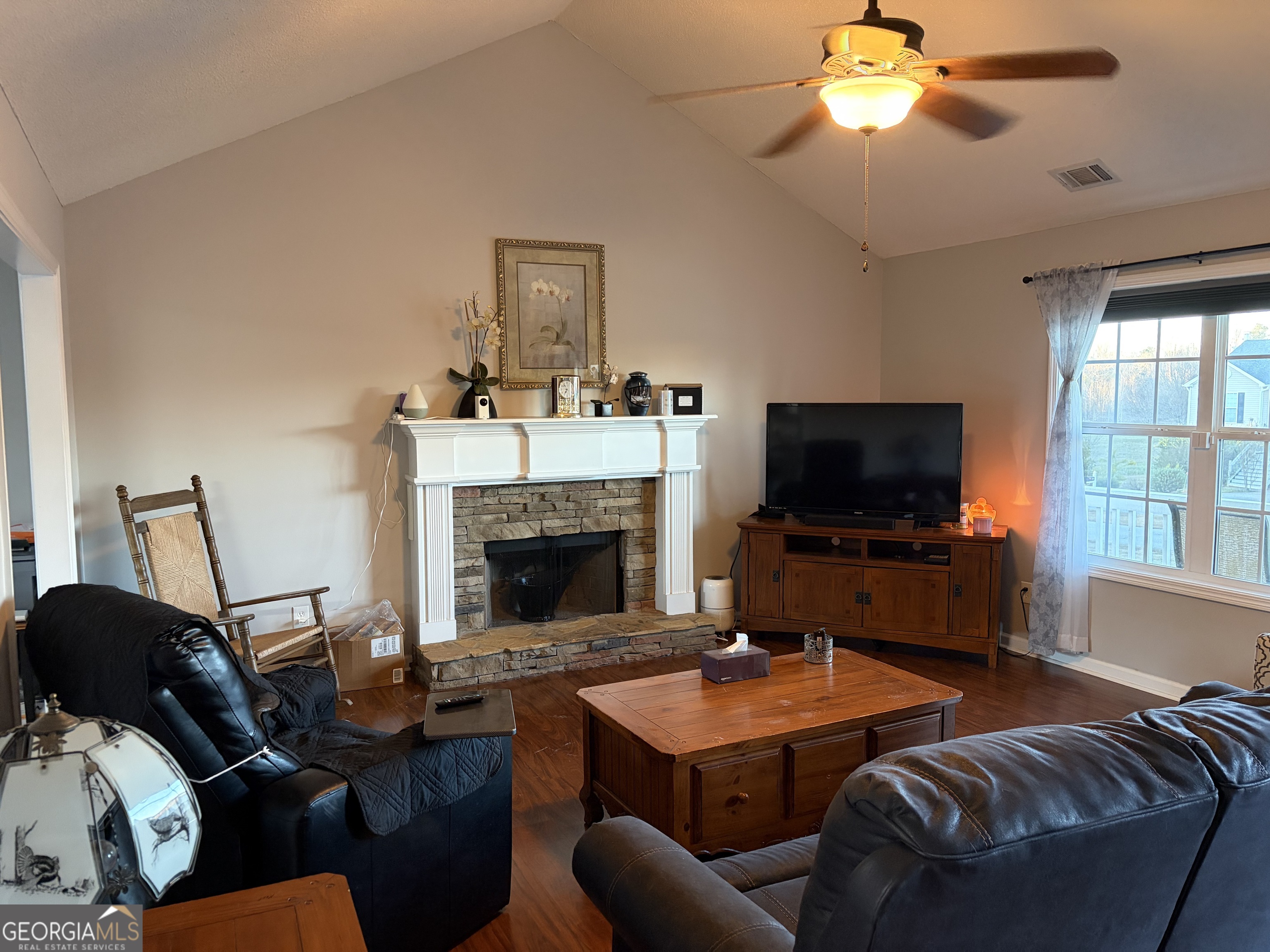137 Stonebrooke Drive Colbert, GA 30628 - Photo 18 of 47 a living room with furniture a flat screen tv and a fireplace
