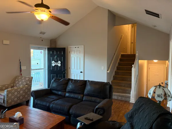 a living room with furniture and a chandelier