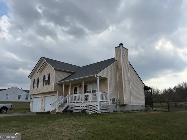 a front view of a house with a garden