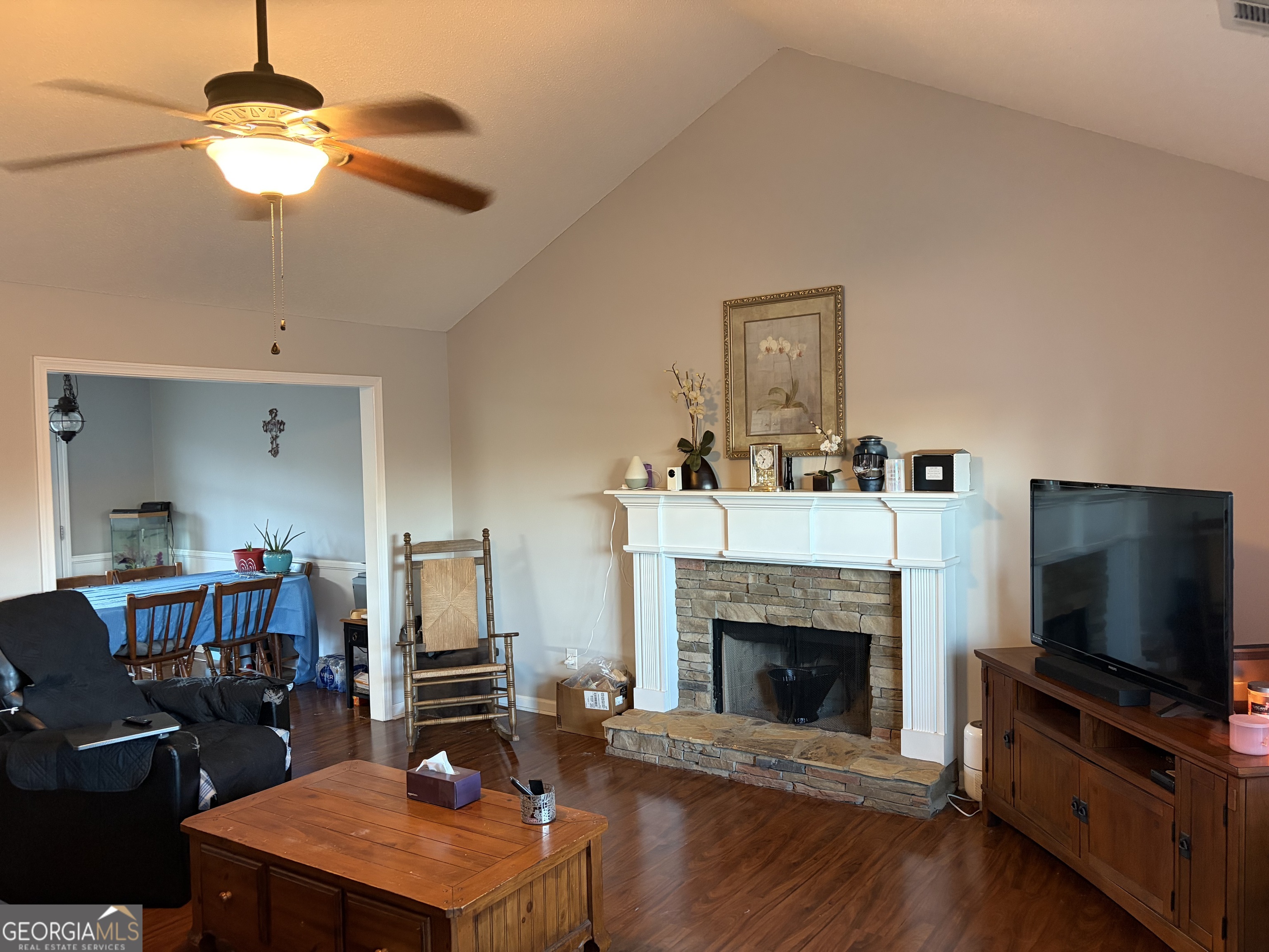 137 Stonebrooke Drive Colbert, GA 30628 - Photo 22 of 47 a living room with furniture a flat screen tv and a fireplace