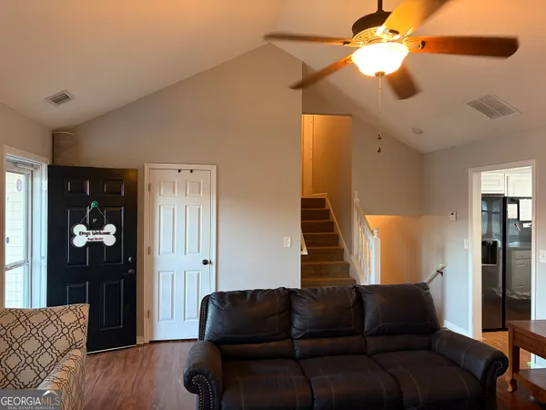 a living room with furniture and a chandelier