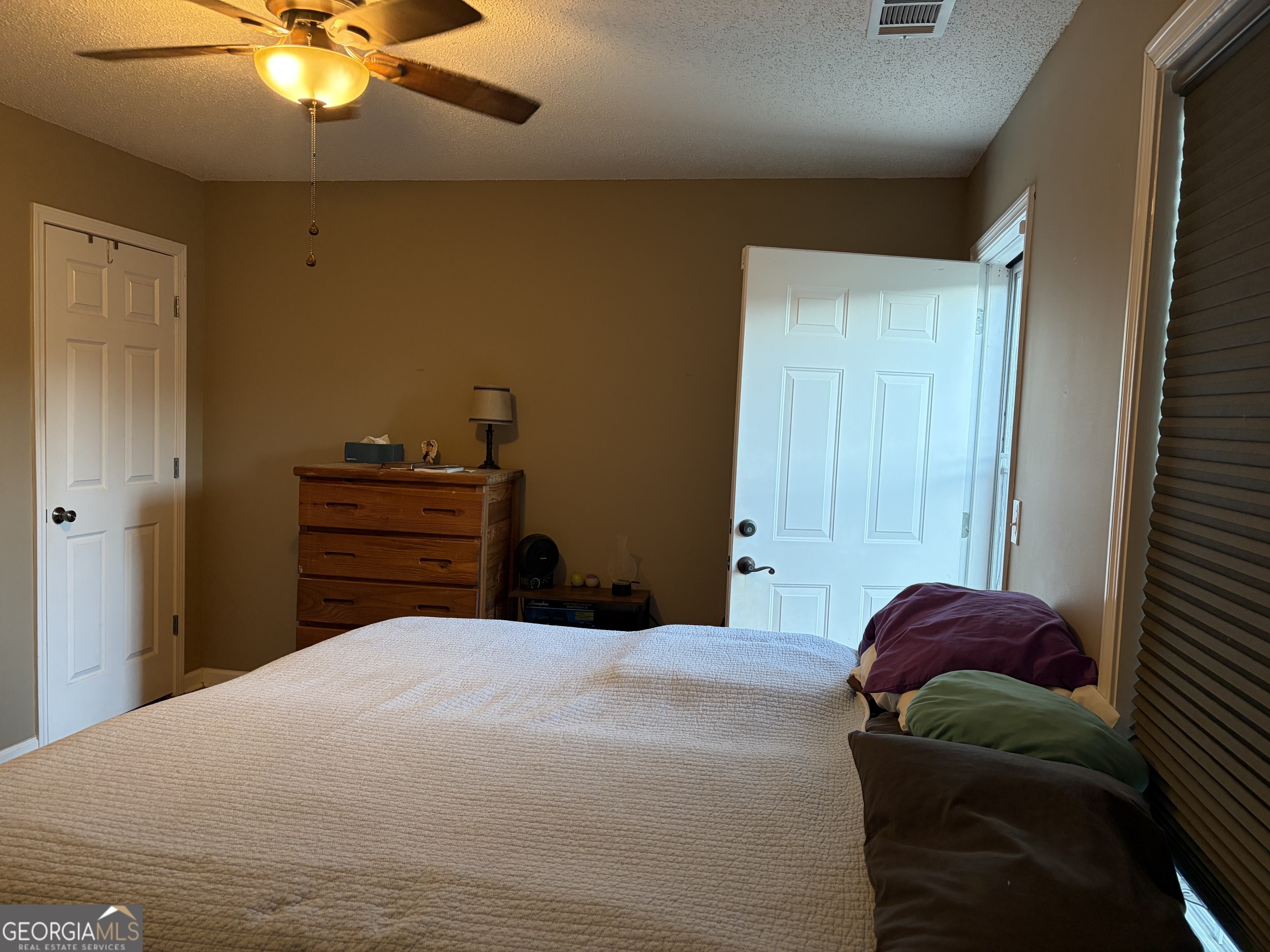 137 Stonebrooke Drive Colbert, GA 30628 - Photo 26 of 47 a bedroom with a bed and a chandelier