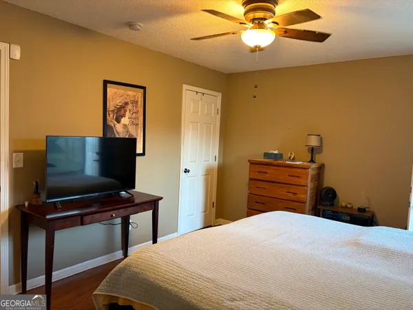 a bedroom with a bed and a flat screen tv