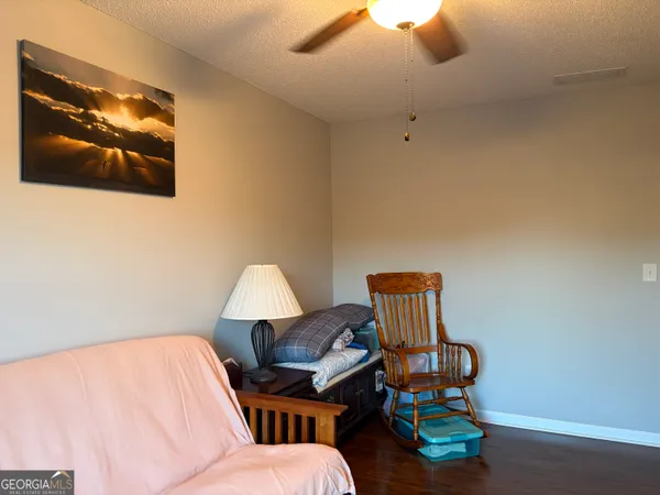 a living room with furniture and a lamp