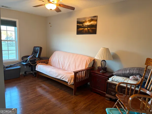 a bedroom with furniture and a window