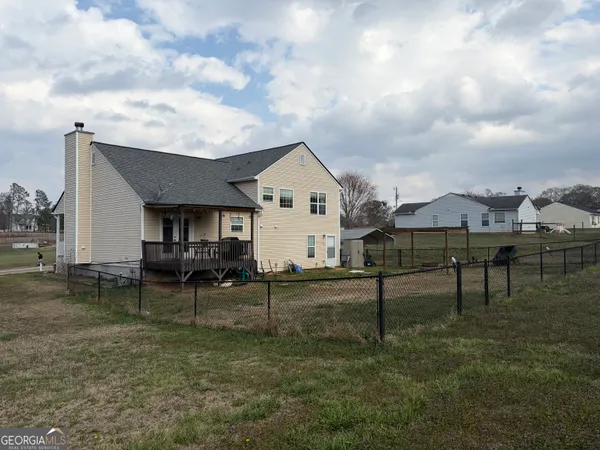 a view of a house with backyard and sitting area