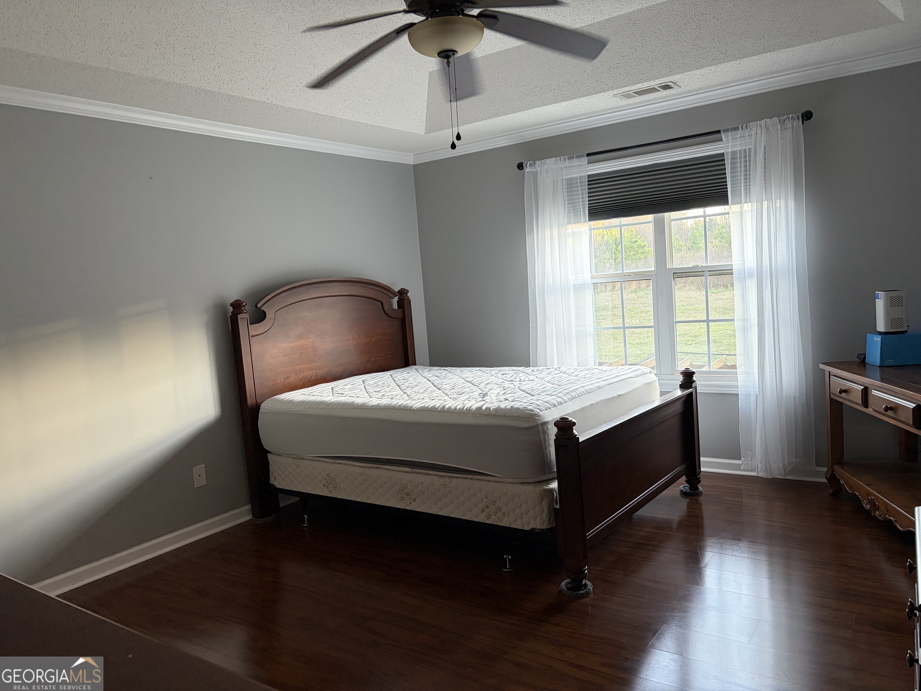 137 Stonebrooke Drive Colbert, GA 30628 - Photo 42 of 47 a bedroom with a bed and wooden floor