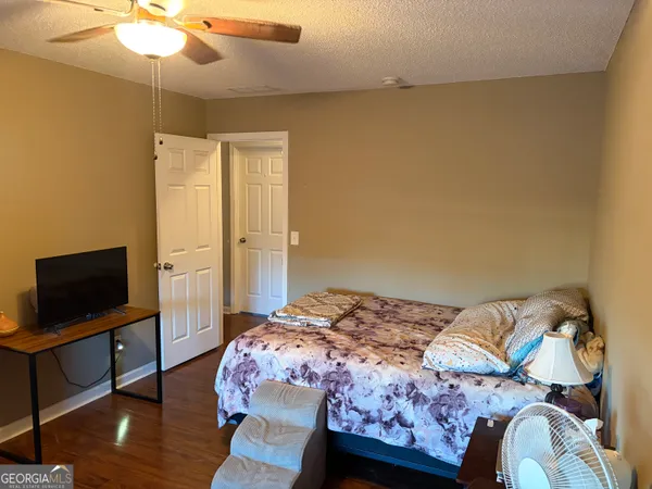a bedroom with a bed and a flat screen tv