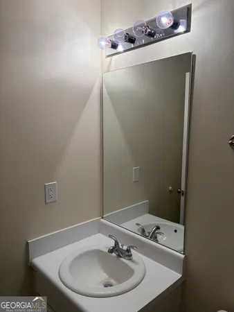 a bathroom with a sink and mirror