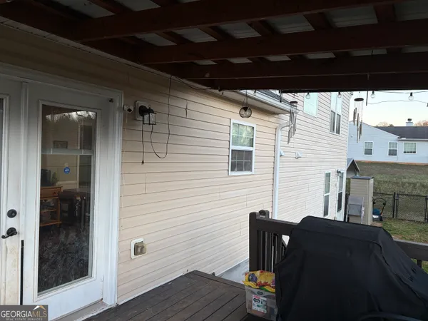 a view of a porch with furniture and wooden floor