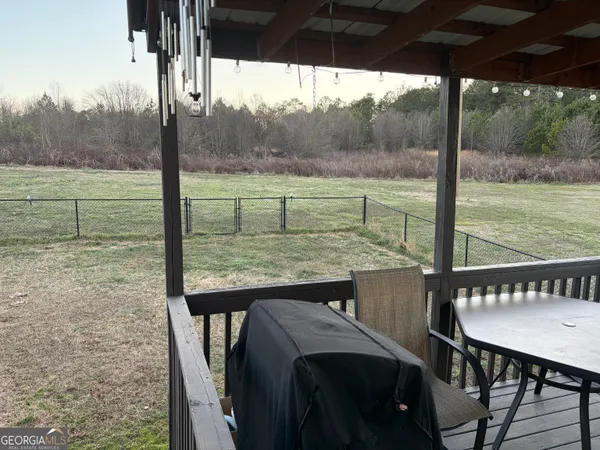a view of a wooden deck and a backyard