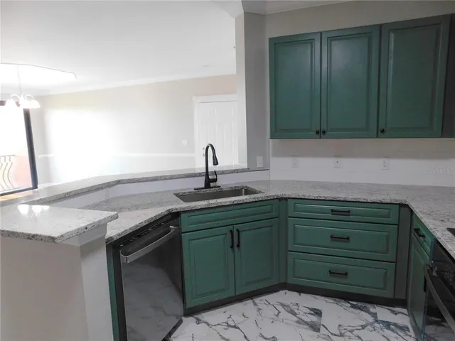 a kitchen with a sink and a mirror