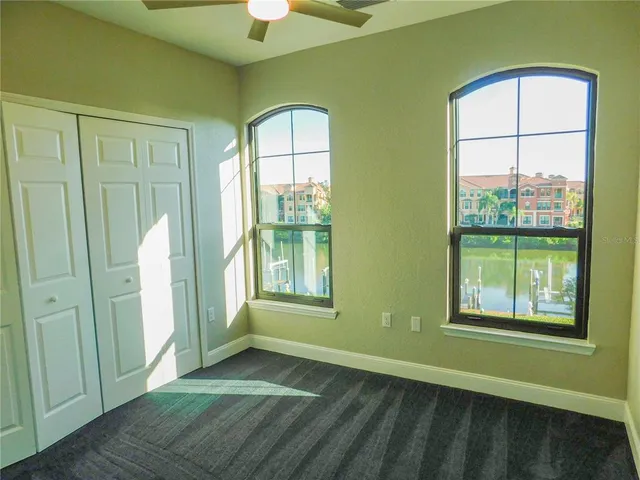 an empty room with windows and closet