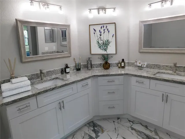 a bathroom with double sink and a mirror