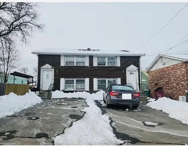 a view of a cars park in front of a house