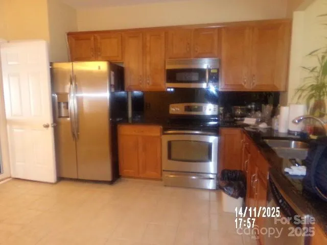 a kitchen with a stove a sink and a microwave