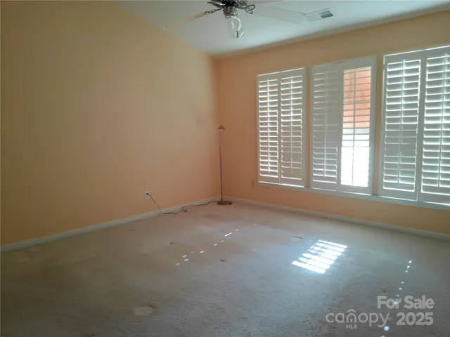 a bedroom with a bed and dresser with mirror