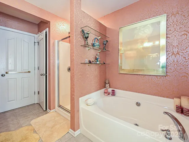 a living room with furniture a chandelier and a window