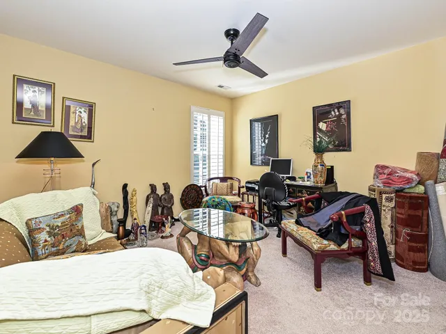 a bedroom with a bed a dresser and a window