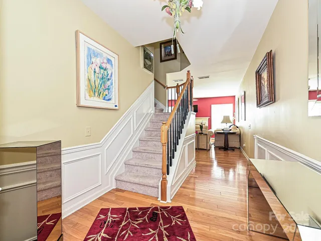 a view of a livingroom with furniture wooden floor and a fireplace