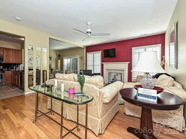 a living room with furniture stove and wooden floor