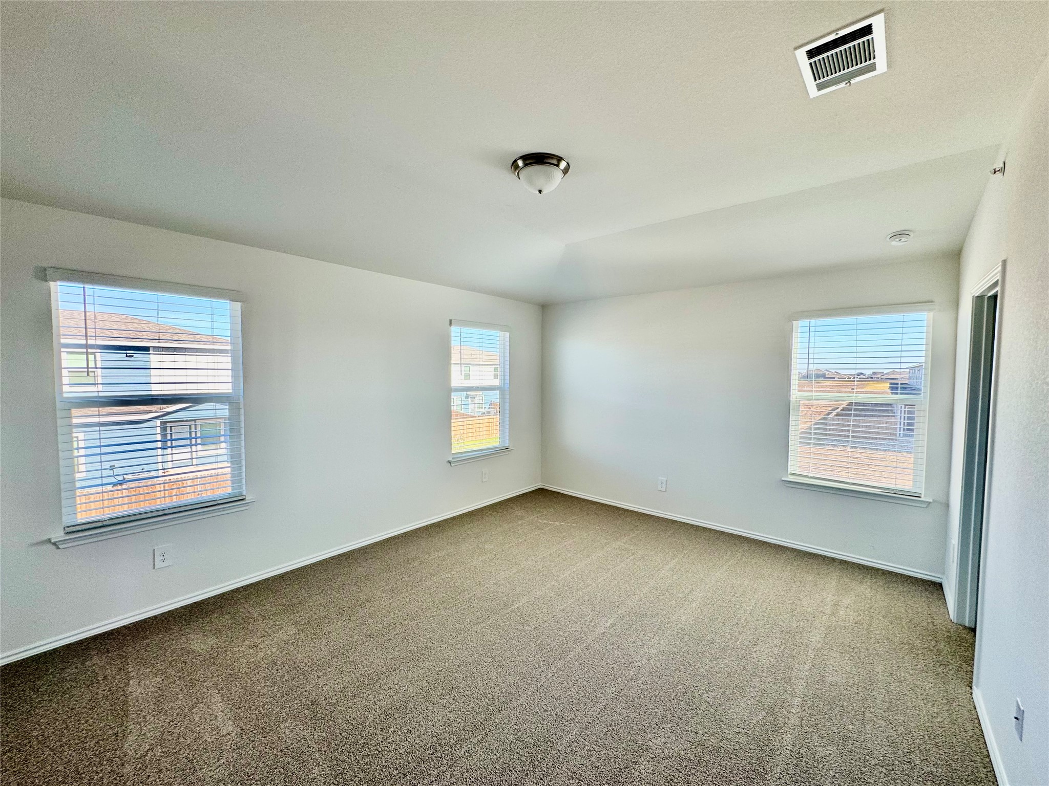 105 Calcite Road, Unit 5 Kyle, TX 78640 - Photo 4 of 6 Carpeted spare room with baseboards