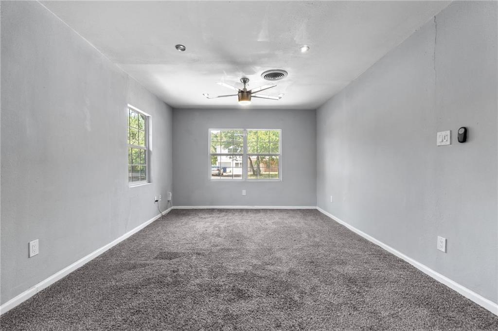 2105 Fortview Road Austin, TX 78704 - Photo 22 of 37 A well-lit bedroom features plush carpeting and multiple windows.