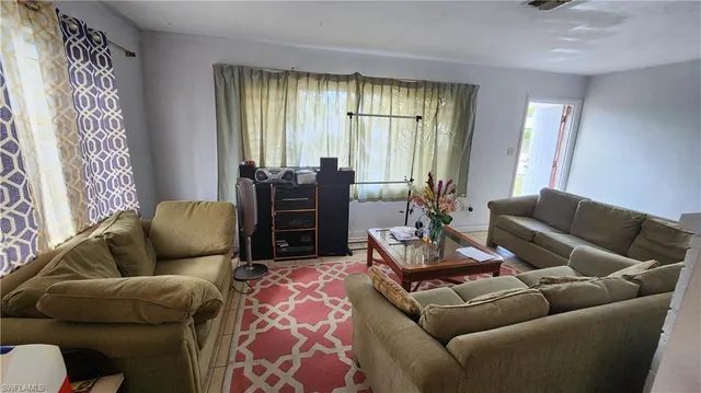 a living room with furniture and windows